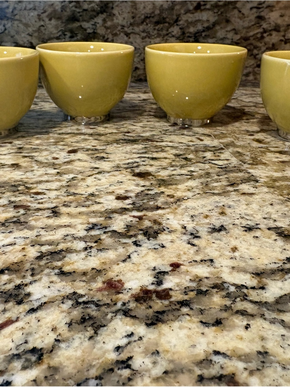 Set of Four Yellow Glazed Ceramic Saki Cups with Silver Trim around Bottom